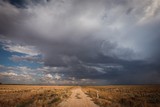 Storm on a country lane in remote central Victoria, Australia. Gravel road surrounded by dry paddocks in times of drought with the hopes of rain.