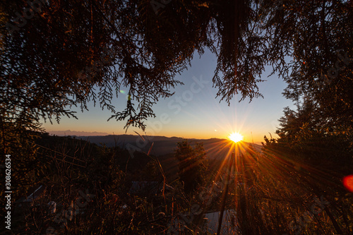 Sunburst in mukteshwar with annapurna ranges on the left. photo