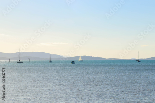 Seaside view of yachts on the water off the coast of Airlie Beach, Queensland Australia