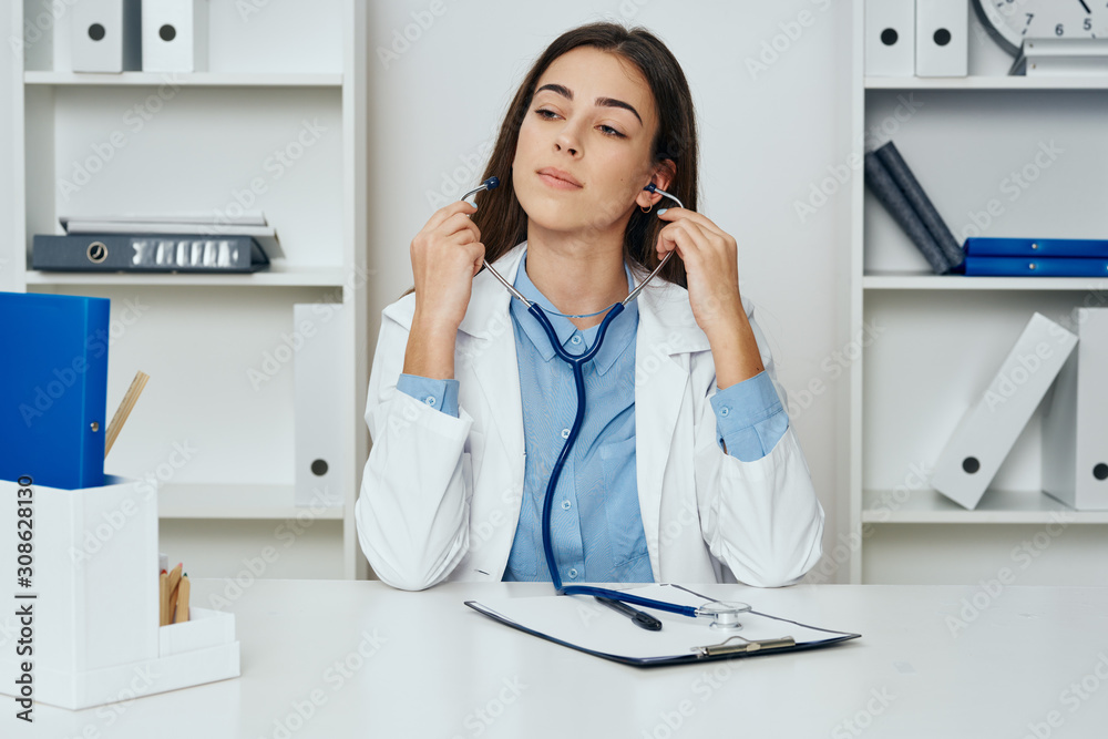 female doctor talking on phone in office