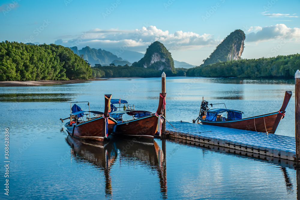 Boat and Twin mountains in the morning. Landmarks of Krabi Province, Thailand.