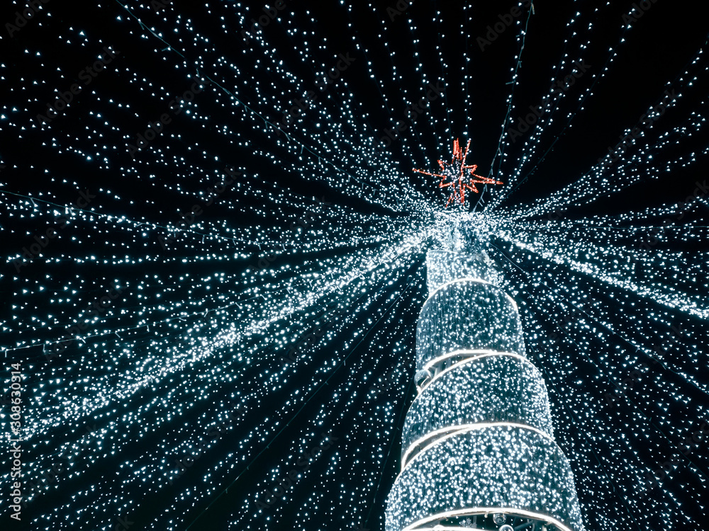 Obraz na płótnie modern christmas tree with led lights coming down from the top of the tree. bottom view w salonie