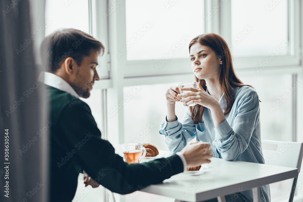 young couple having breakfast in the kitchen young couple having breakfast in the kitchen