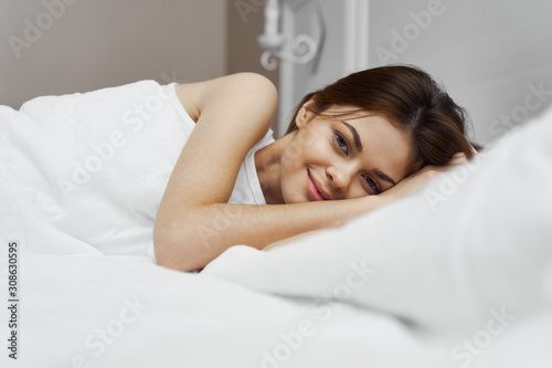 young woman lying on bed