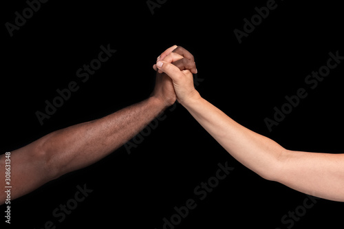 African-American man shakes hands with Caucasian woman