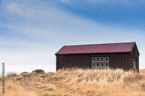 old red barn in field