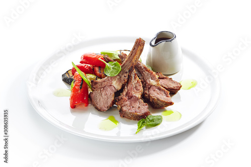 Grilled Lamb Rack with Baked Vegetables on White Restaurant Plate