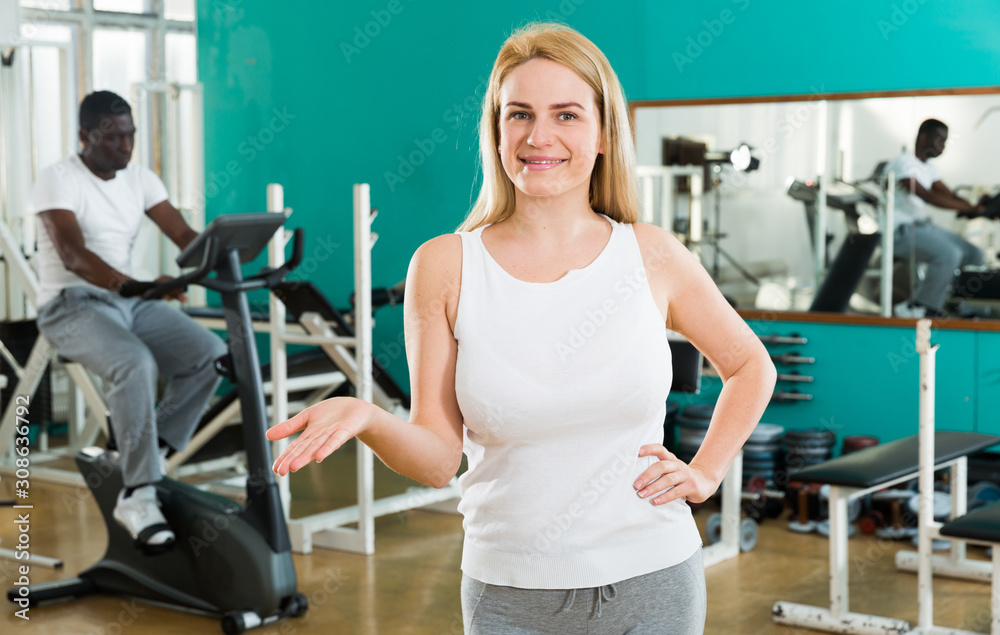 Friendly girl welcoming to gym