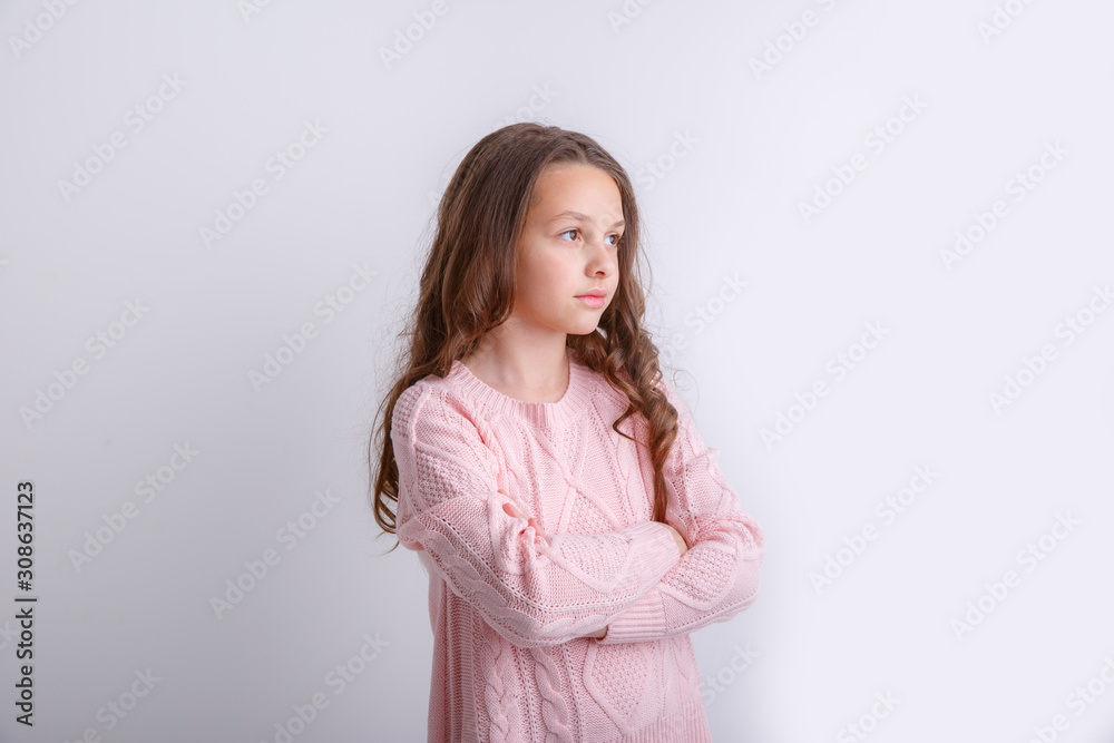 a little brunette girl shows different emotions joy, sadness, surprise isolated on white background a little brunette girl shows different emotions joy, sadness, surprise isolated on white background