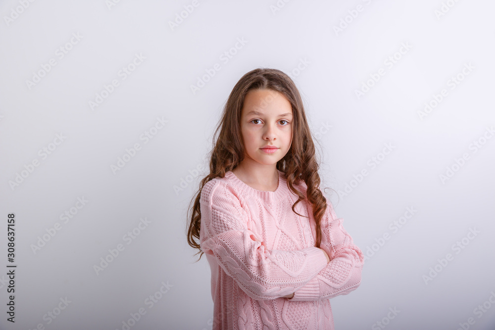 a little brunette girl shows different emotions joy, sadness, surprise isolated on white background a little brunette girl shows different emotions joy, sadness, surprise isolated on white background