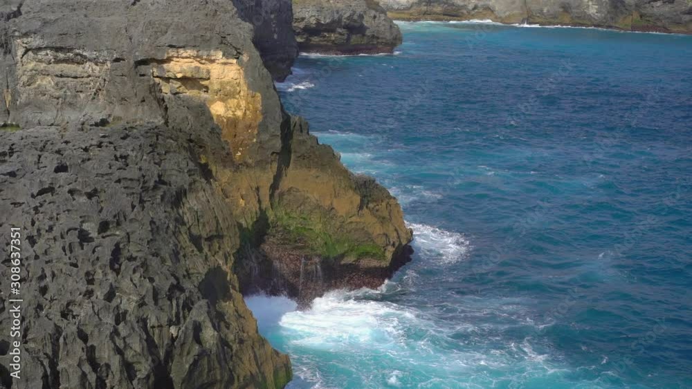waves are breaking on the rocks at the Angel's Billabong beach at the Nusa Penida island, Indonesia. Slowmotion shot waves are breaking on the rocks at the Angel's Billabong beach at the Nusa Penida island, Indonesia. Slowmotion shot