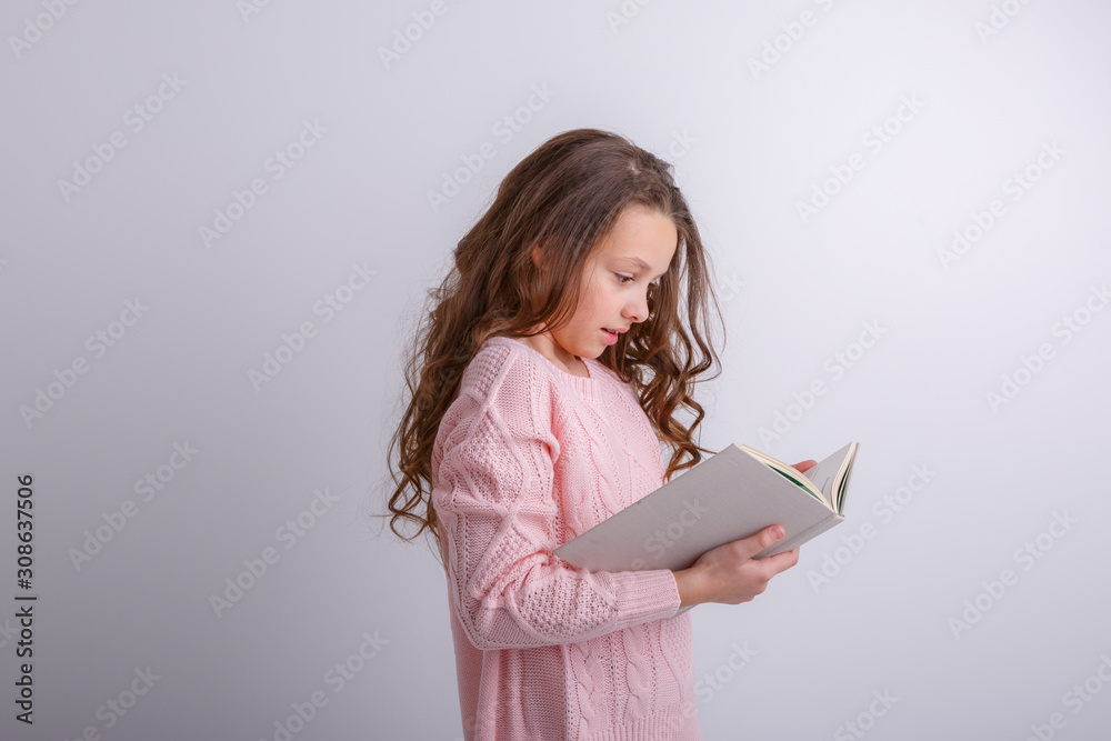 a little girl with a book smiling isolated on a white background a little girl with a book smiling isolated on a white background