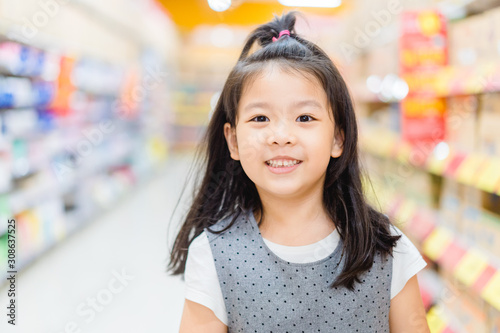 Wallpaper Mural 5.8 years old funny little child girl.Little asian girl standing on the trolley and smile when she shopping in supermarket. Torontodigital.ca