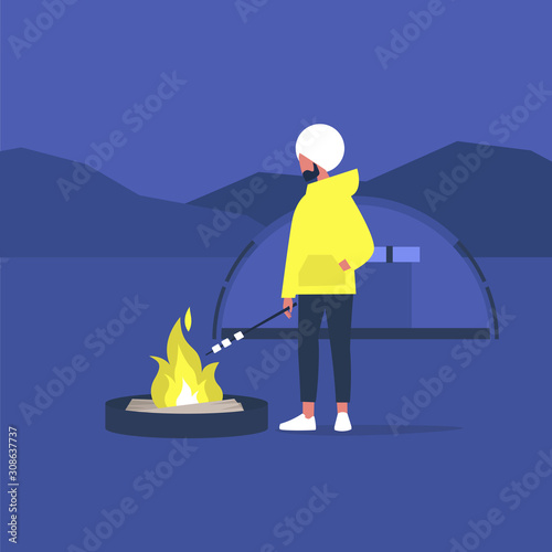hiking in forest, young indian male tourist roasting marshmallows on a campfire,