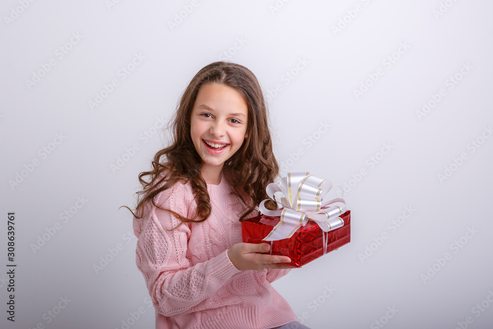 little girl smiling looking at gift on isolated white background little girl smiling looking at gift on isolated white background