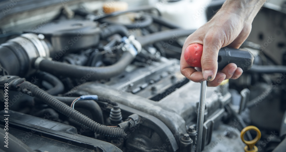 Mechanic working in car motor. Auto repair, Service center Mechanic working in car motor. Auto repair, Service center
