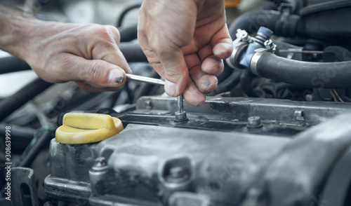 Mechanic working in car motor. Auto repair, Service center