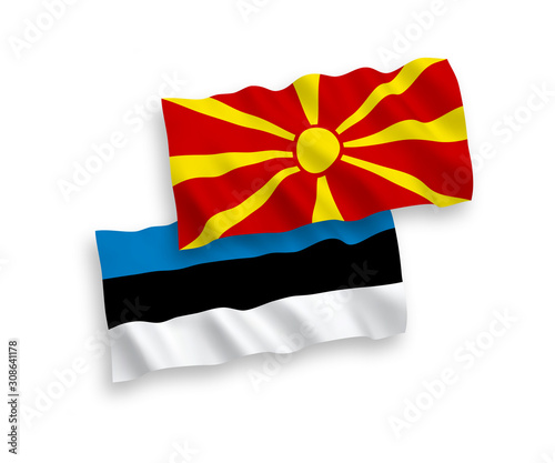 National vector fabric wave flags of Estonia and North Macedonia isolated on white background. 1 to 2 proportion.