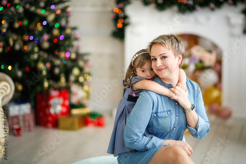 child in dress in her mother’s arms, Christmas