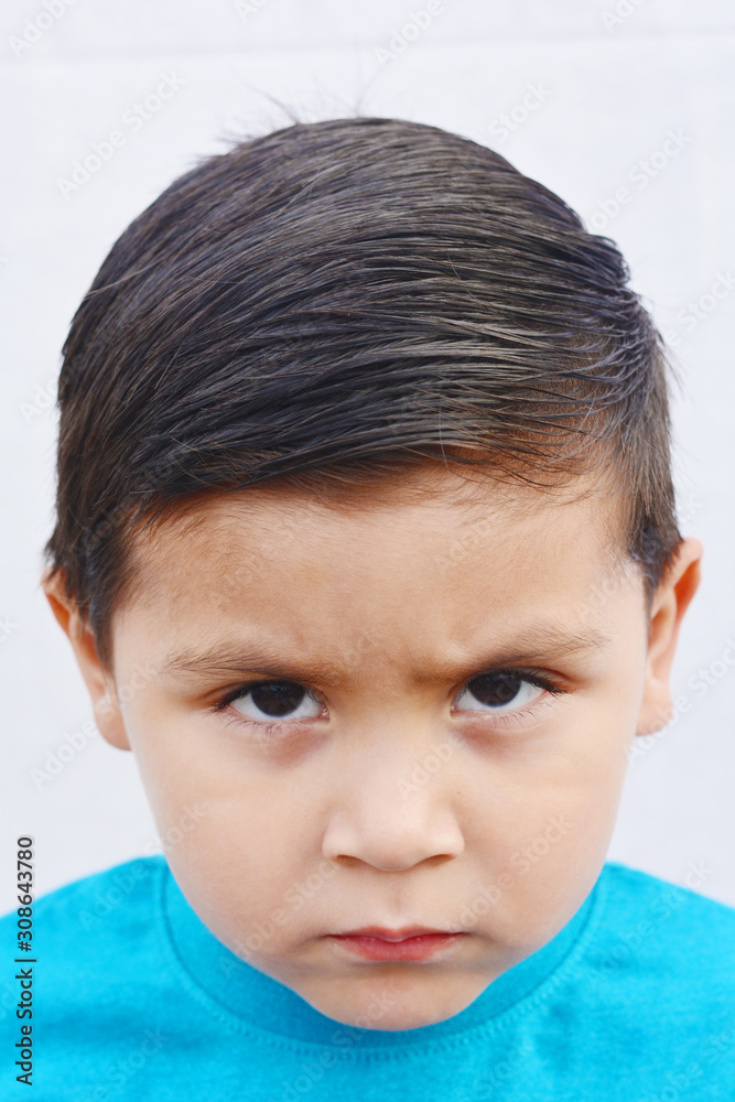 Unhappy little latin boy. White background. Unhappy little latin boy. White background.