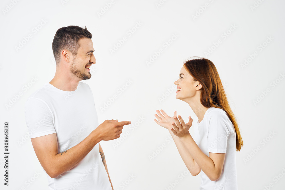 young couple in t-shirts chatting young couple in t-shirts chatting