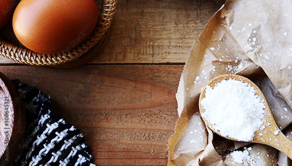 Bread and flour - Baking on wood background with egg and pastry flour Bread and flour - Baking on wood background with egg and pastry flour