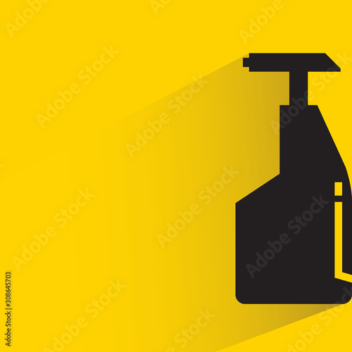 spray bottle with drop shadow in yellow background