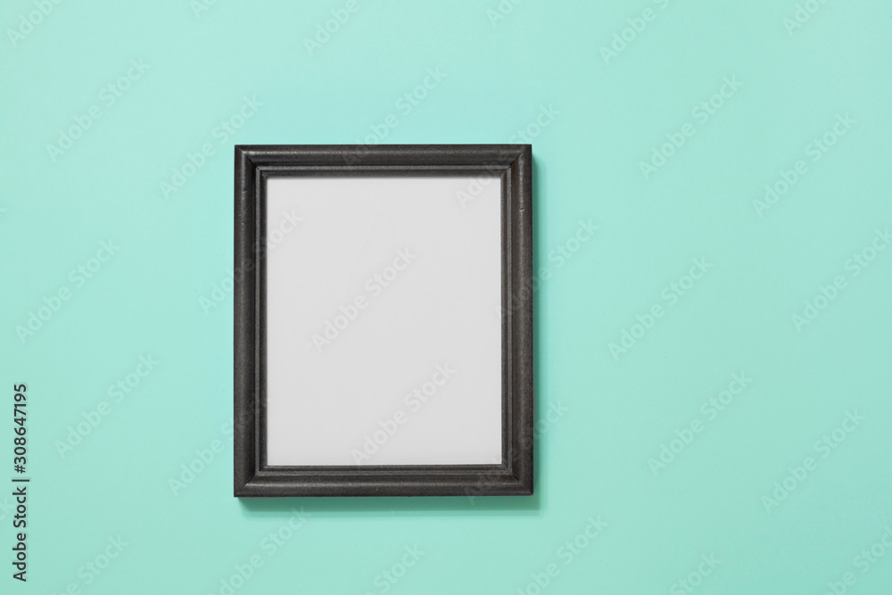 Black photo frame on light green background. Black photo frame on light green background.