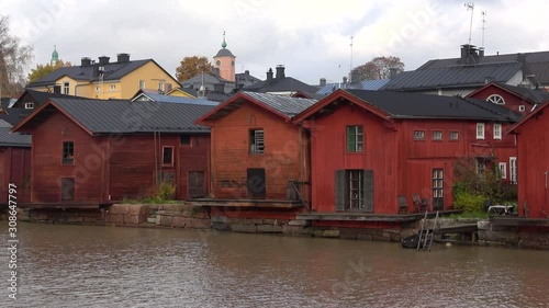 The old red wooden barns on the banks of the Porvoonjoki river close-up on an October day. Porvoo. Finland photo