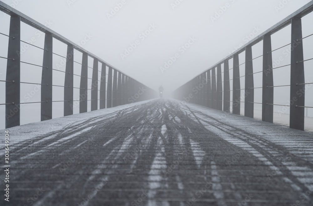 Slippery bicycle bridge during a foggy, winter morning. Slippery bicycle bridge during a foggy, winter morning.