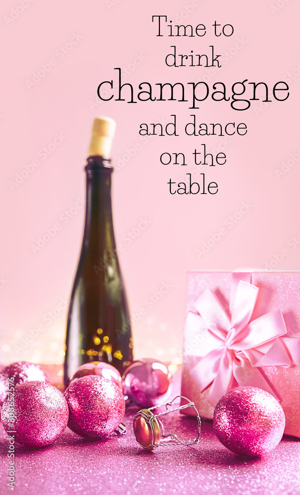Foto Stock Time to drink champagne and dance on the table - greeting card.  Bottle of wine, party accessories over abstract pink glitter background.  winter holiday concept. | Adobe Stock