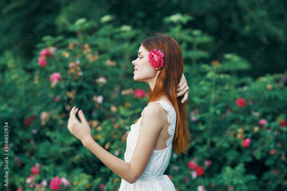 young woman in the park with flowers young woman in the park with flowers