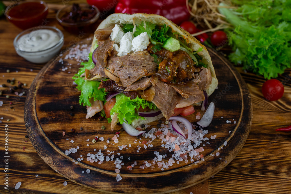 doner kebab on dark wooden kitchen table doner kebab on dark wooden kitchen table