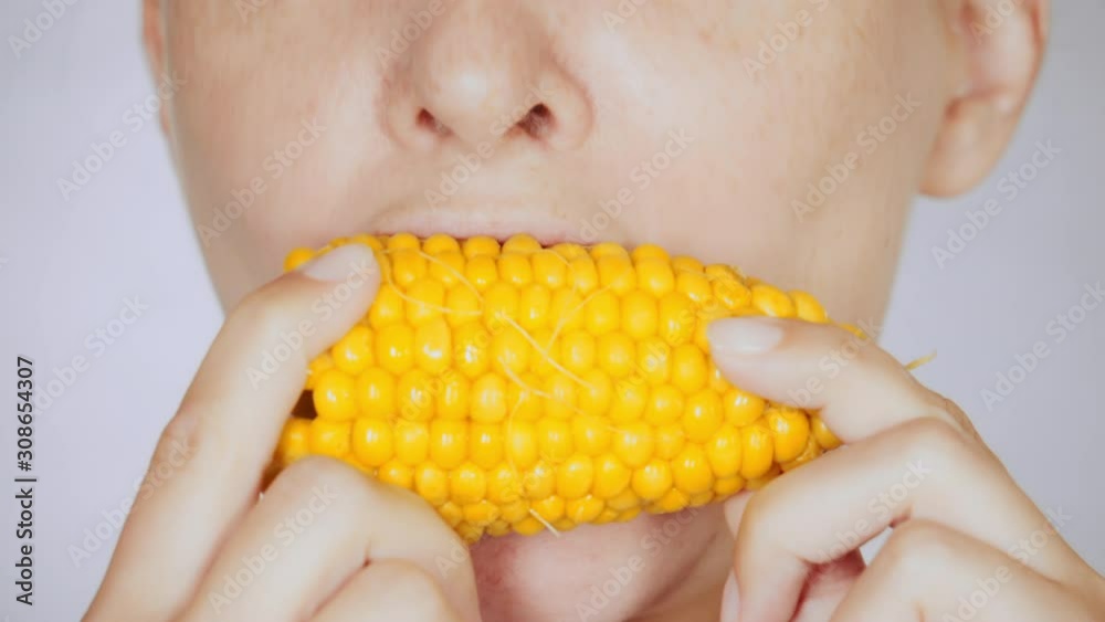 lower face caucasian female with freckles eats corn portrait lady bites and chews lower face caucasian female with freckles eats corn portrait lady bites and chews