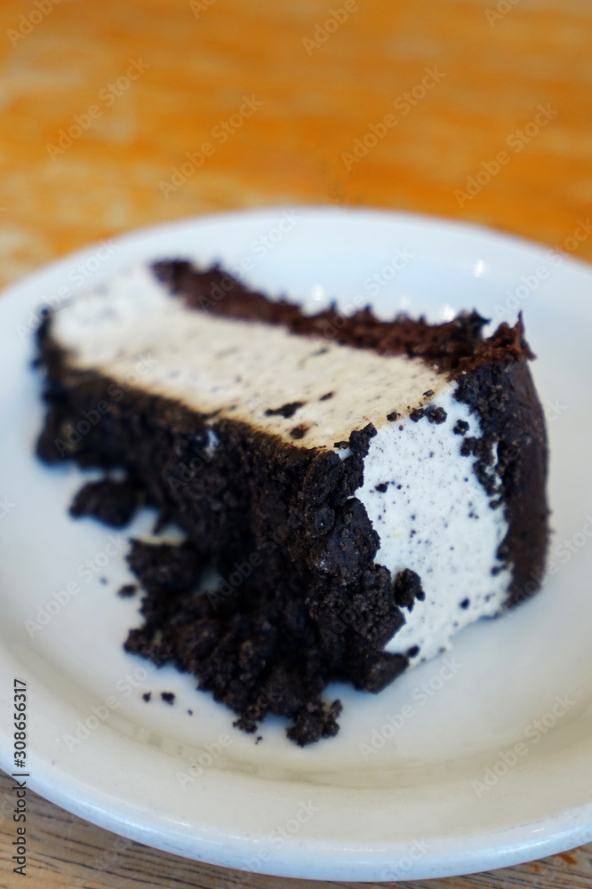 Close up slice of cookie and cream cheesecake on wooden table Close up slice of cookie and cream cheesecake on wooden table