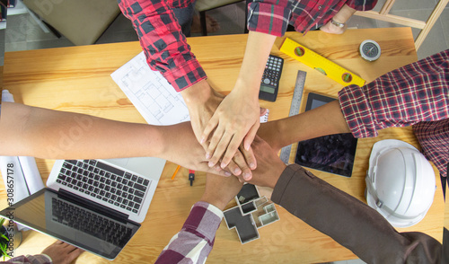 Engineer or architect people coordinate hands in office. Concept Teamwork.