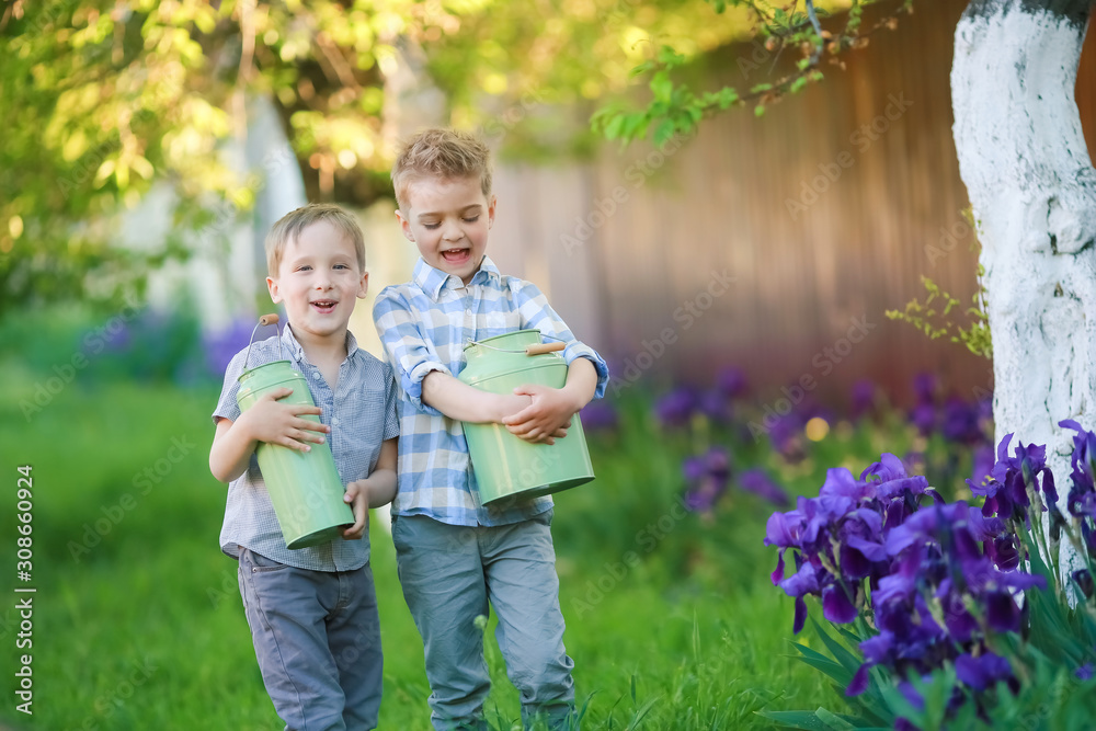 Two handsome brothers having fun while sitting outside in garden. Two handsome brothers having fun while sitting outside in garden.