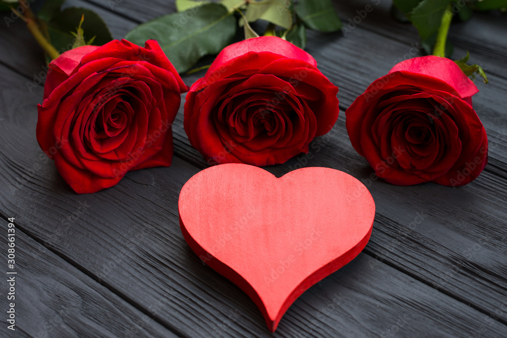 Red heart and red roses on dark wooden background Red heart and red roses on dark wooden background