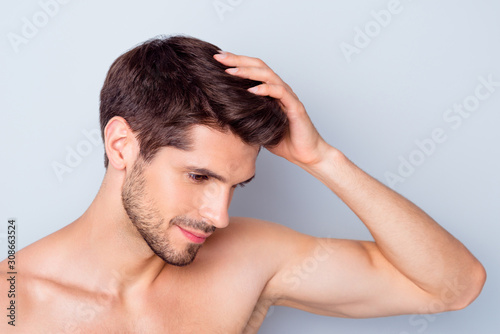 Close-up portrait of nice attractive stylish confident peaceful bearded brown-haired guy touching silky healthy shine hair anti alopecia effect isolated on light white grey color pastel background