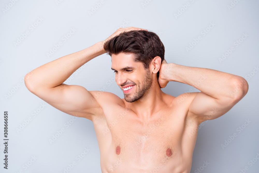 Closeup photo of macho guy holding hands in perfect hair looking mirror toothy smiling naked torso masculine body groomed appearance isolated grey background Closeup photo of macho guy holding hands in perfect hair looking mirror toothy smiling naked torso masculine body groomed appearance isolated grey background