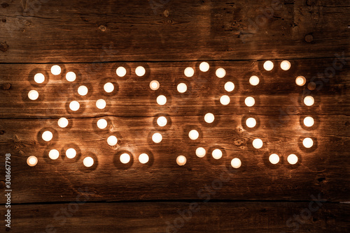 2020 new year concept with tealight candles on wooden background