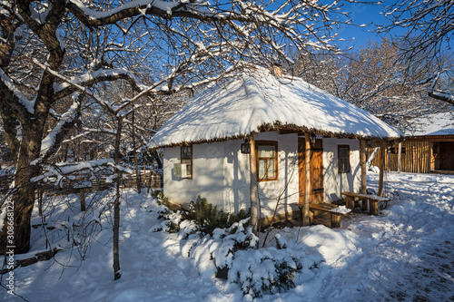 ukrainian peasant  house covered with snow © phant