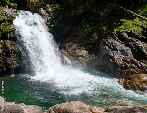 Thundering emerald colored punchbowl waterfall North Fork Sauk River Falls of the north cascades in a rocky gorge off Mountain Loop Highway in Darrington Snohomish county Washington State  photo