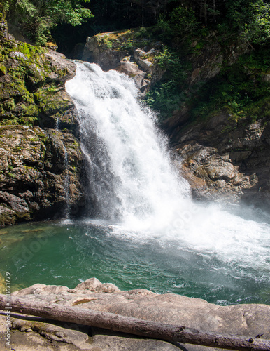 Thundering emerald colored punchbowl waterfall North Fork Sauk River Falls of the north cascades in a rocky gorge off Mountain Loop Highway in Darrington Snohomish county Washington State  photo