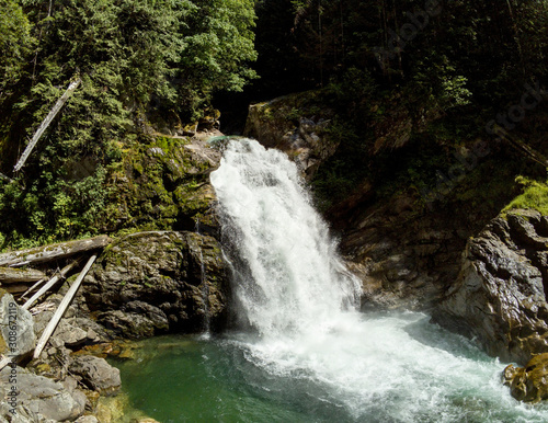 Thundering emerald colored punchbowl waterfall North Fork Sauk River Falls of the north cascades in a rocky gorge off Mountain Loop Highway in Darrington Snohomish county Washington State  photo