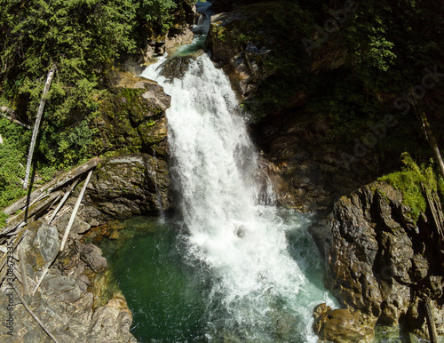 Thundering emerald colored punchbowl waterfall North Fork Sauk River Falls of the north cascades in a rocky gorge off Mountain Loop Highway in Darrington Snohomish county Washington State  photo
