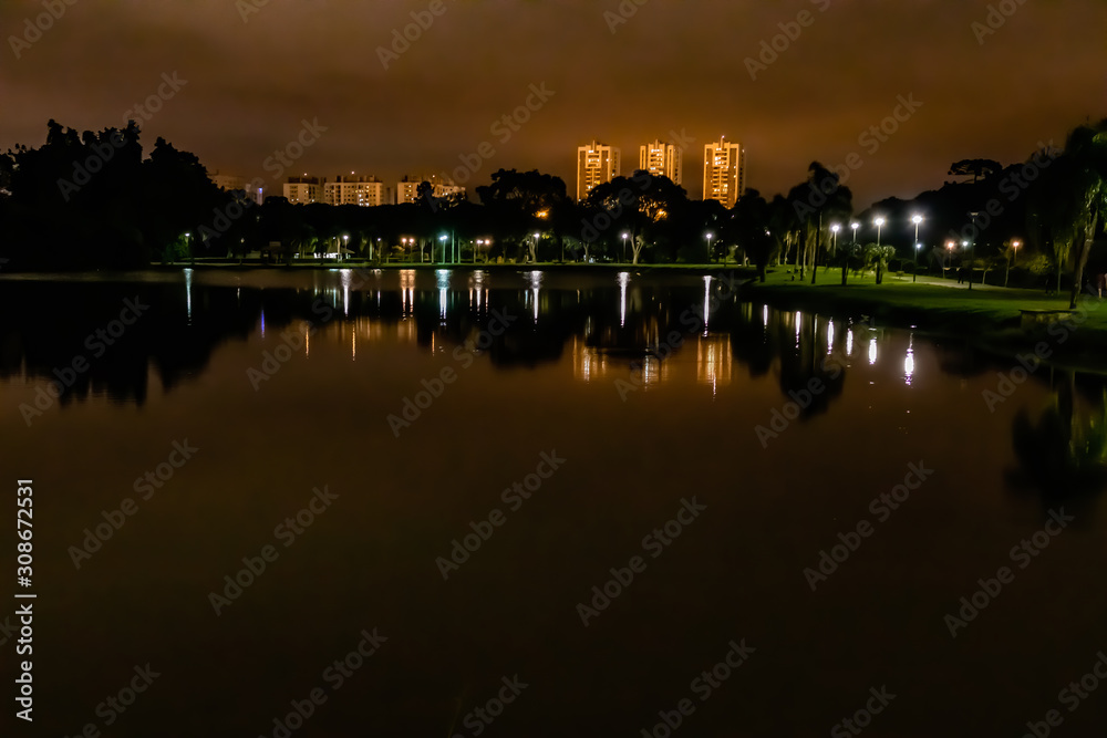 At the beginning of the night, the lights of the city reflect on the water