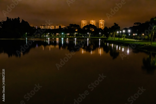 At the beginning of the night, the lights of the city reflect on the water