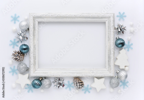 Christmas composition. Photo frame, christmas decorations on white background. Flat lay, top view, copy space