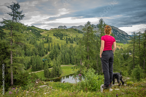 hikers in the austrian alps walk on mountain hiking trails in the woods around the lakes photo